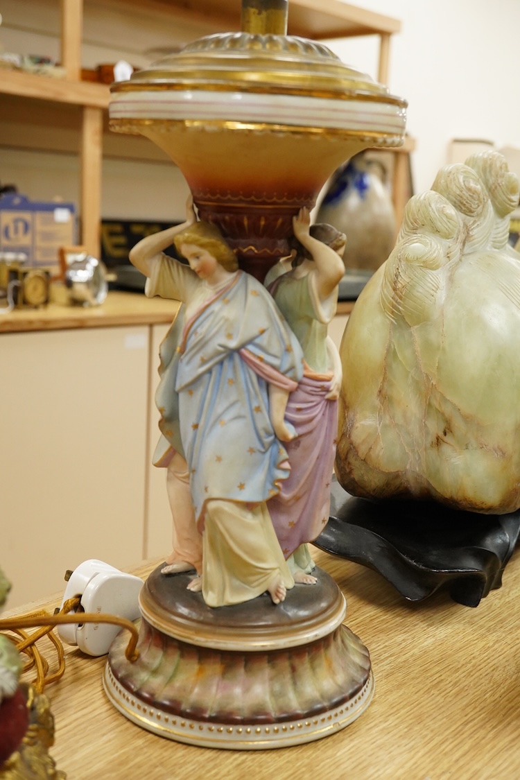 A Continental Three Graces table lamp and another table lamp mounted with a seated figure, largest 44cm high including the fitting